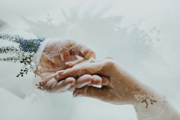 Bride's hand resting on lace